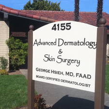Photograph of the Advanced Dermatology & Skin Surgery Clinic sign in front of the clinic